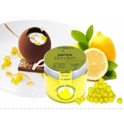 Jar of yellow Zitron lemon gourmet pearls with fresh lemon and a garnished chocolate dessert
