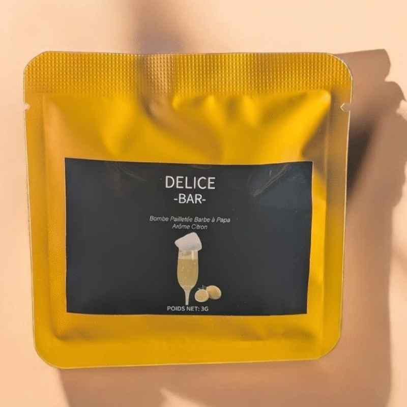 Sachet jaune de bombe à paillettes barbe à papa saveur citron Délice Bar