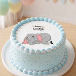 Gâteau bleu avec un disque comestible d’éléphanteau endormi et le message Happy Birthday